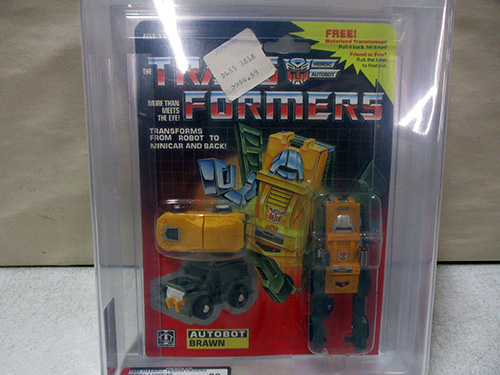image of Factory-Sealed 1980s Transformers Autobot Brawn Action Figure AFA graded