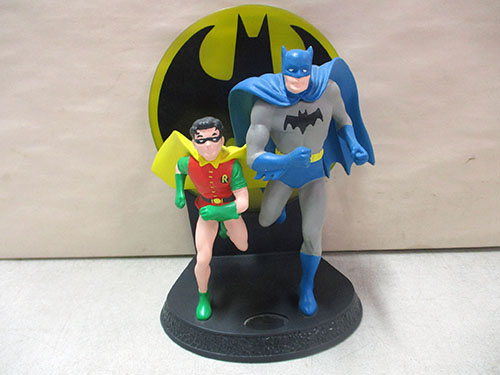 image of Batman and Robin Figurine on Display Stand