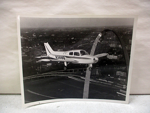 image of Beechcraft Airplane Photograph Over City