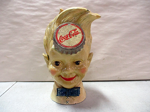 image of Cast Iron Coca-Cola Advertising Figurine with Bottle Cap Design