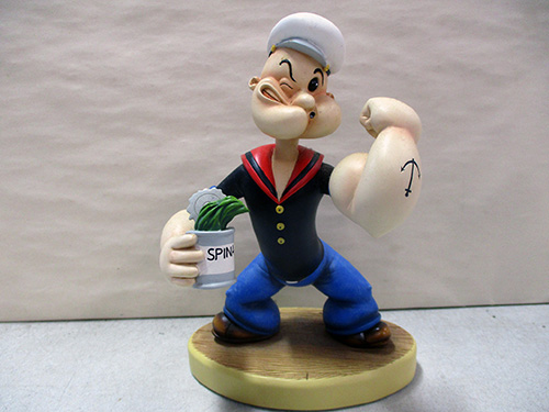 image of Popeye Figurine Holding Spinach Can on Wooden Base